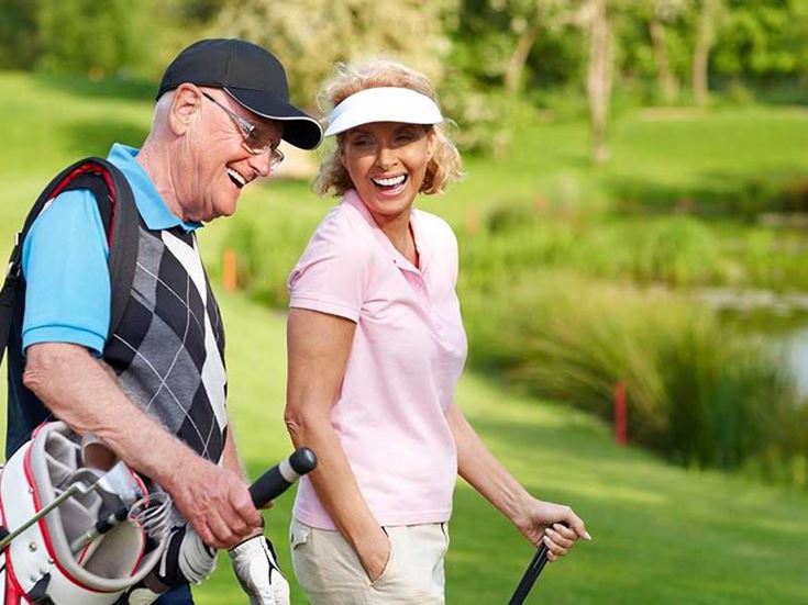 a man and woman on a golf course