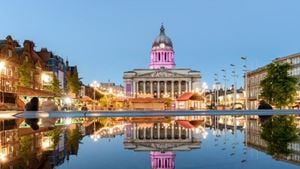Nottingham Council House during twilight hours, with its reflection shown in a fountain in Old Market Square.