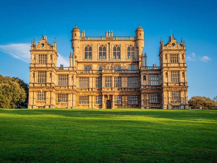 A lush green lawn in front of Wollaton Hall in Nottingham.