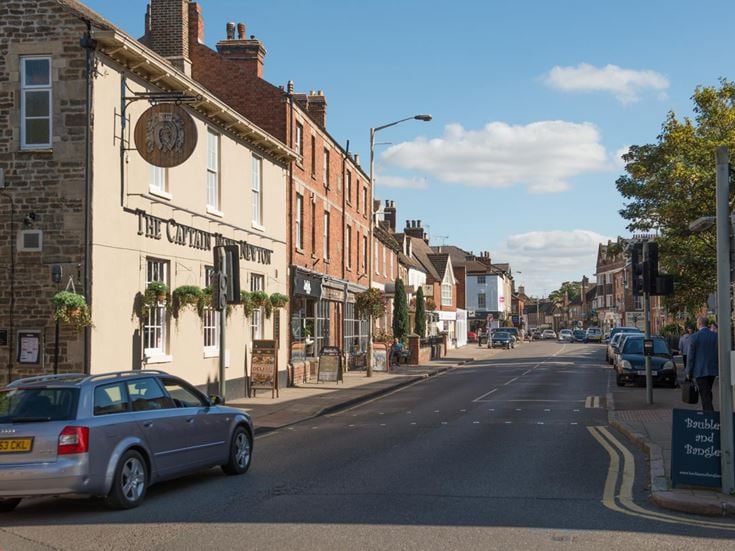 A street in Oakham with shops and eateries.