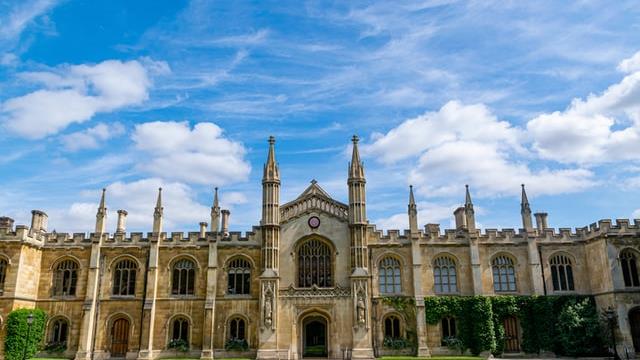 A green lawn in front of a historic Cambridge University building in Cambridgeshire.