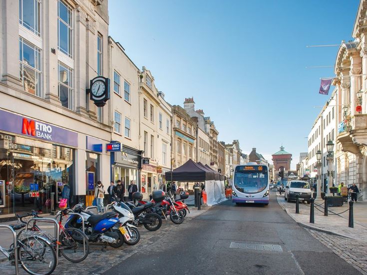 A bus and Metro Bank on a busy high street in Colchester.