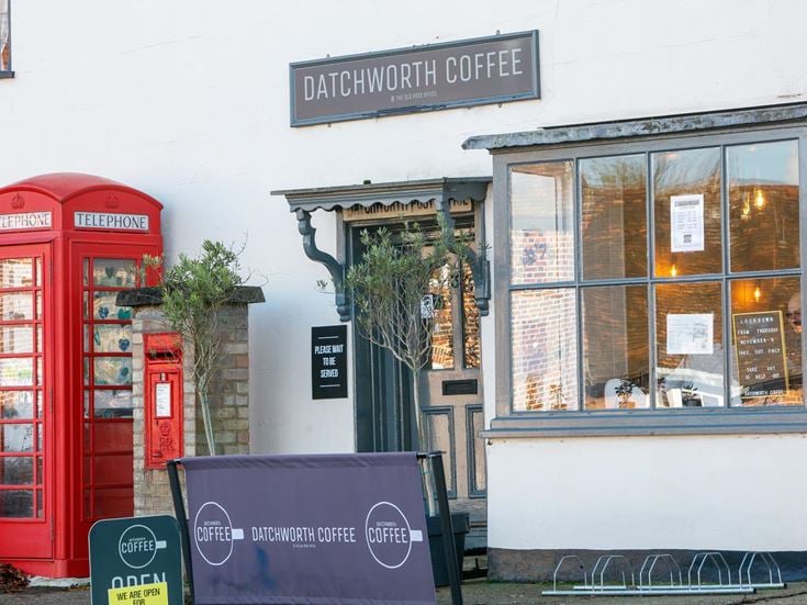 A photo of Datchworth Coffee, a cafe in Knebworth, with a red telephone box outside.
