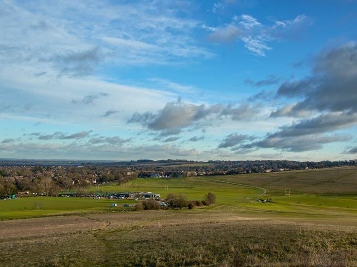 a large open field with a few buildings in it
