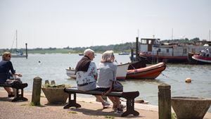 Two retirees sitting on a bench and enjoying the waterside near Martlesham Heath.