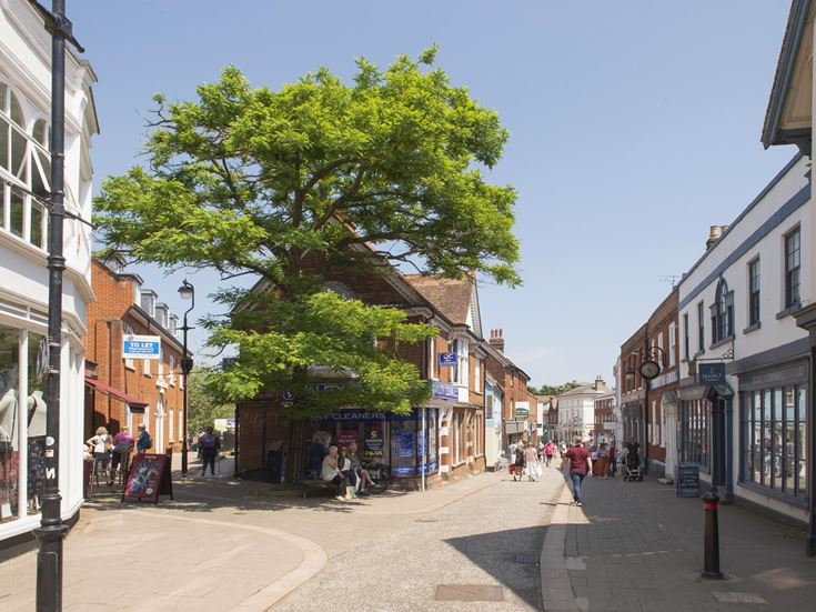 Two roads in Martlesham Heath’s village centre, on a street lined with shops.