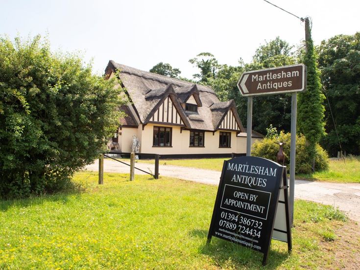 Two signs pointing people to visit Martlesham Antiques, which is open by appointment.