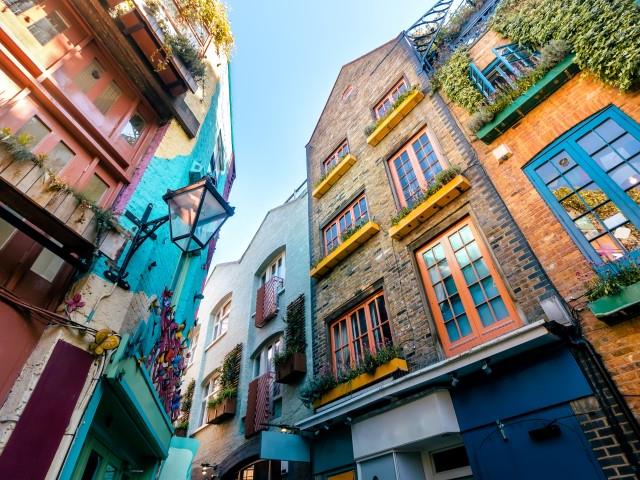 A colourful collection of brick buildings in Covent Garden, with yellow, orange and blue windowpanes.