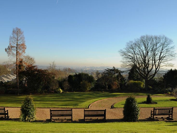 A hint of the London skyline from the green grounds of Harrow School.