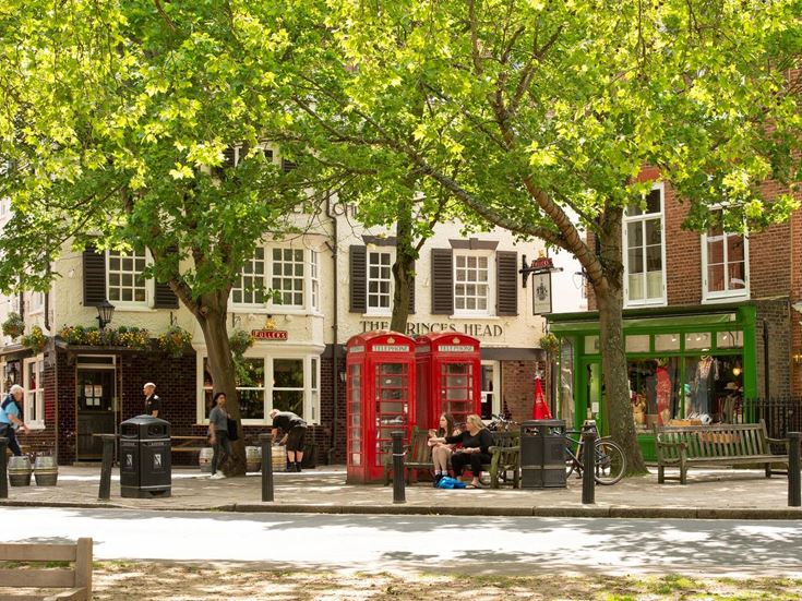 Pubs, shops, and seating areas in Iselworth.