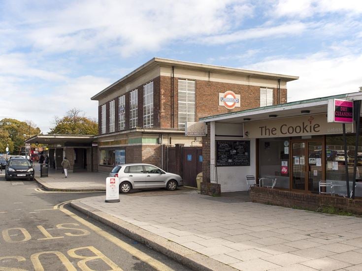 Entrance to Oakwood underground station next to a bakery.