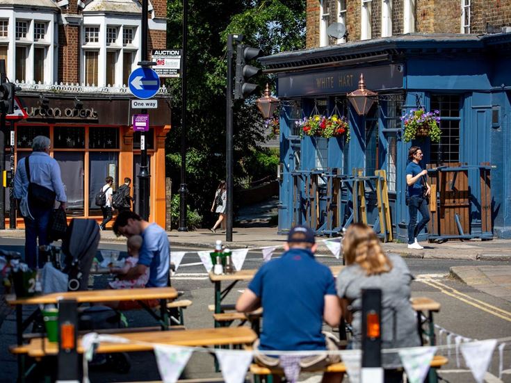 people sitting outside near pub
