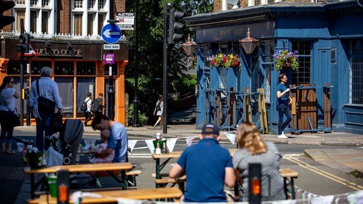 people sitting outside near pub