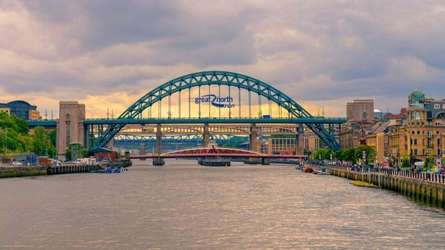 Three bridges crossing the River Tyne in Newcastle city, with a sign for the Great North Run.