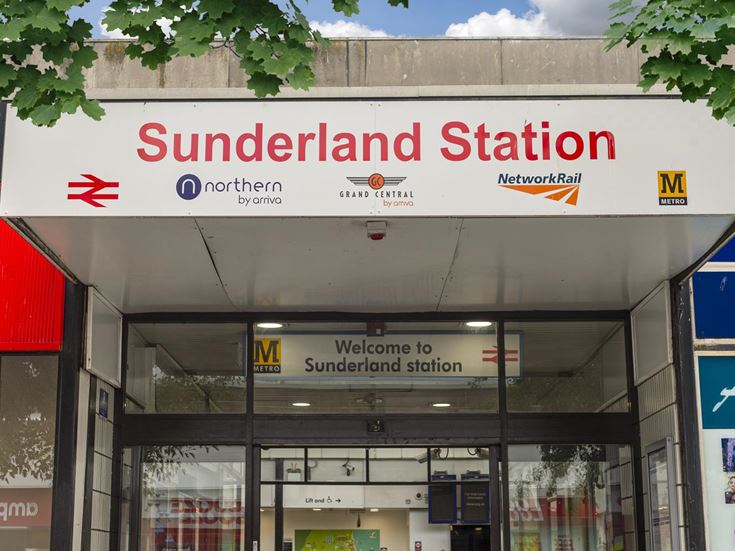 A photo of Sunderland Train Station, with logos of various train companies below the name.