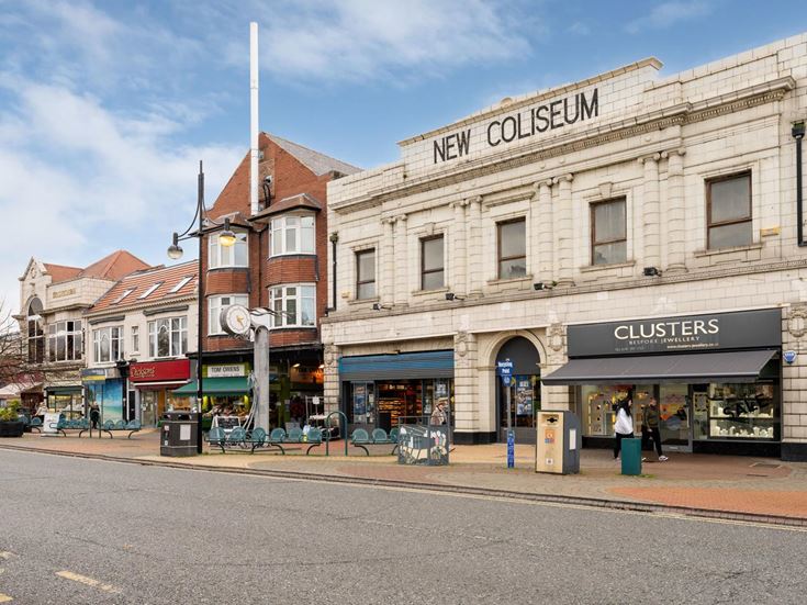 Shops and cafes on a street in Whitley Bay centre.