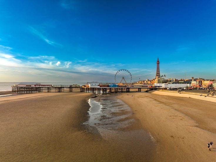 A view of Blackpool beach, central pier, big wheel and the famous Tower.