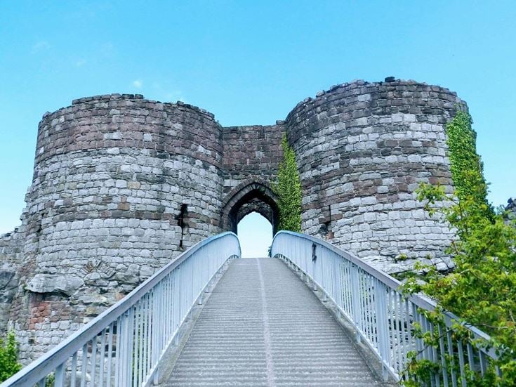 A bridge leading into an archway entrance to Beeston Castle in Cheshire.