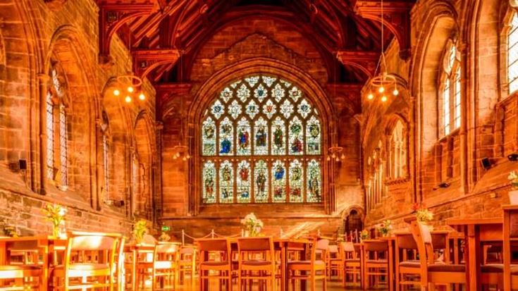 he interior of Chester Cathedral, lit with an amber glow.