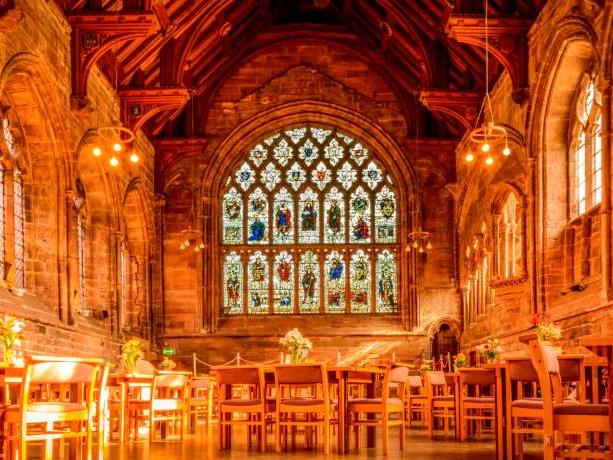 he interior of Chester Cathedral, lit with an amber glow.
