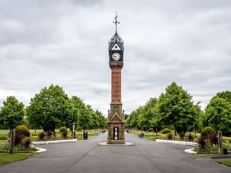 a clock tower in a park