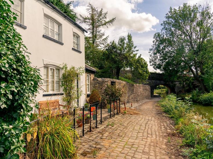 House overlooking a cobbled path in Macclesfield.