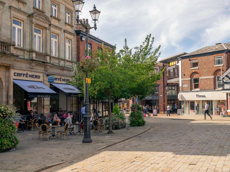 ‘Macclesfield town centre, with cafes and shops nearby.