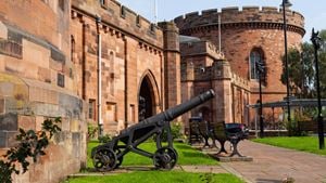 Carlisle Citadel’s striking red sandstone walls and historic cannon on a sunny day in the city.