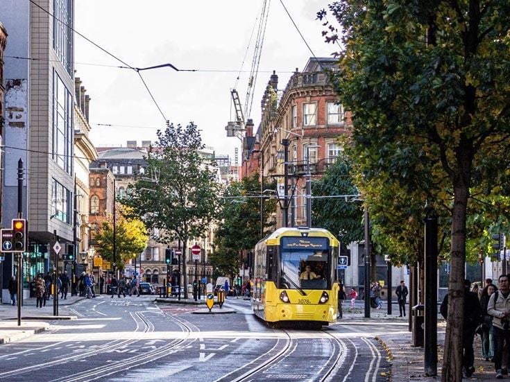 Princess Street in Manchester with a yellow tram in the foreground