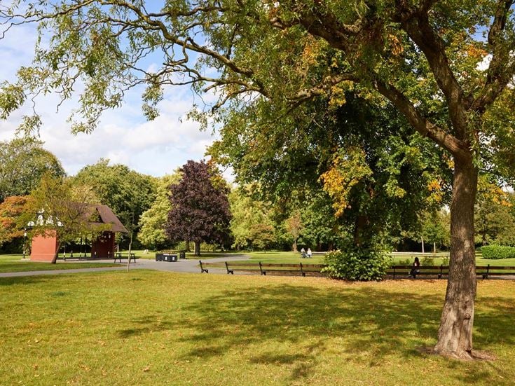 Cale Park in Davenport featuring mature trees, seating and level footpaths.