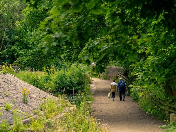 Two retirees enjoy a walk through Daisy Nook Country Park.
