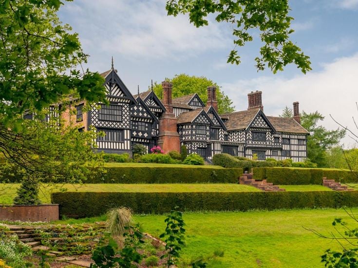 View from a lawn of Bramall Hall Tudor manor house.