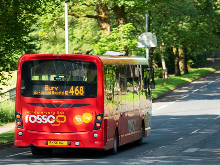 A red bus en-route to Bury.