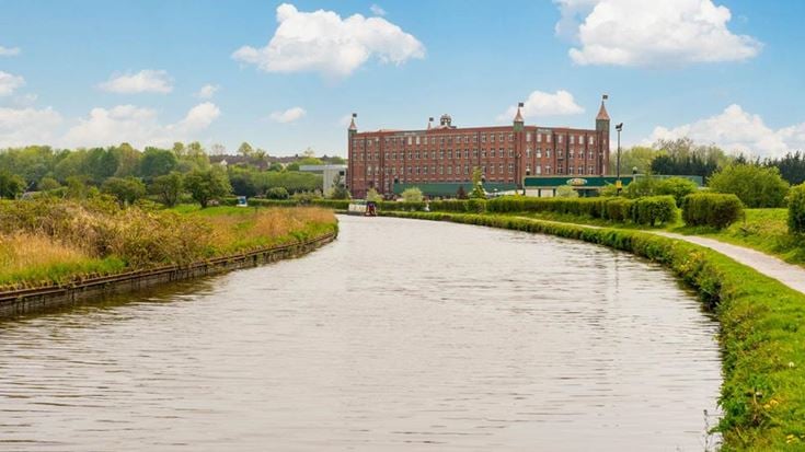 a river with a building in the background