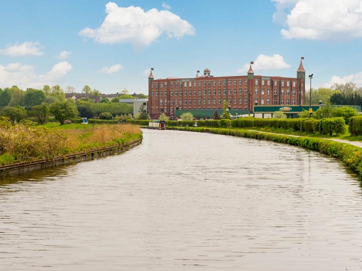 a river with a building in the background