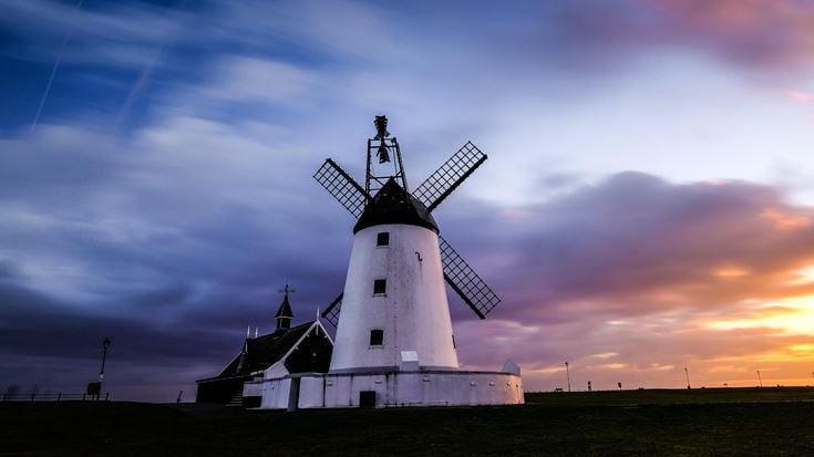 a white building with a windmill