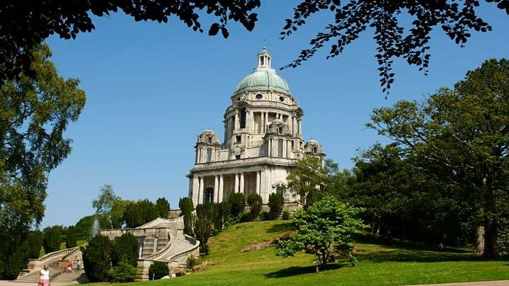 A view of Ashton Memorial in Williamson Park, Lancaster, from a flat pathway.