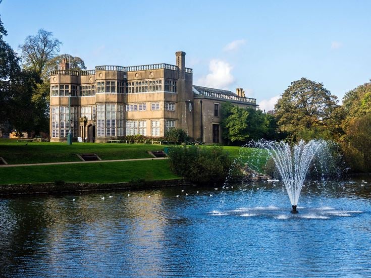 a large building with a fountain in front of it