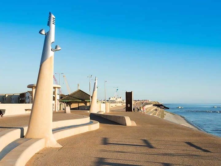 a walkway next to a beach