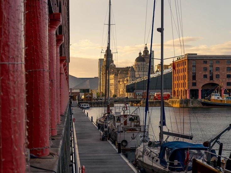 a dock with boats and buildings