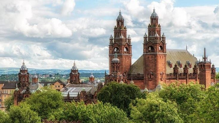 a large building with towers and trees in front of it with Mainz Cathedral in the background