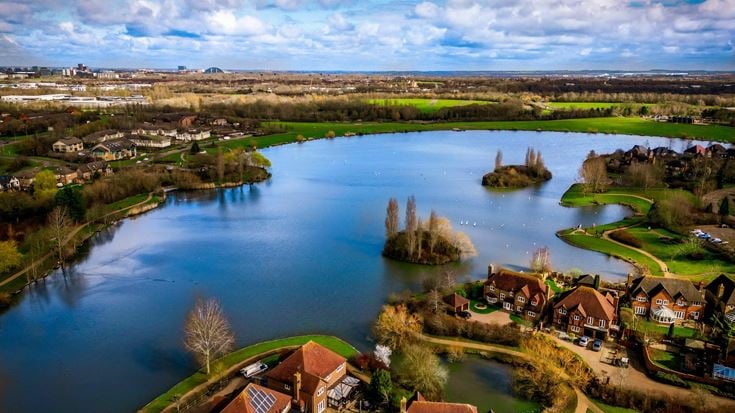 Aerial view of a town situated near a river in Milton Keynes
