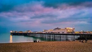 Brighton Palace Pier in Brighton seen from the beachfront during twilight hours.