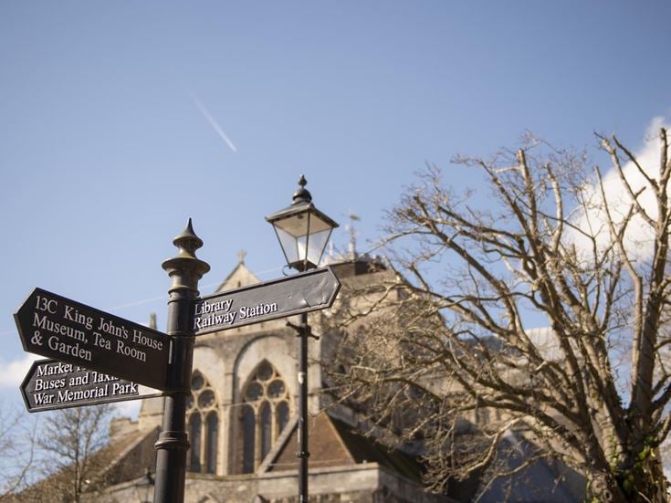 Signpost in Romsey showing directions to local amenities, attractions, and transport hubs