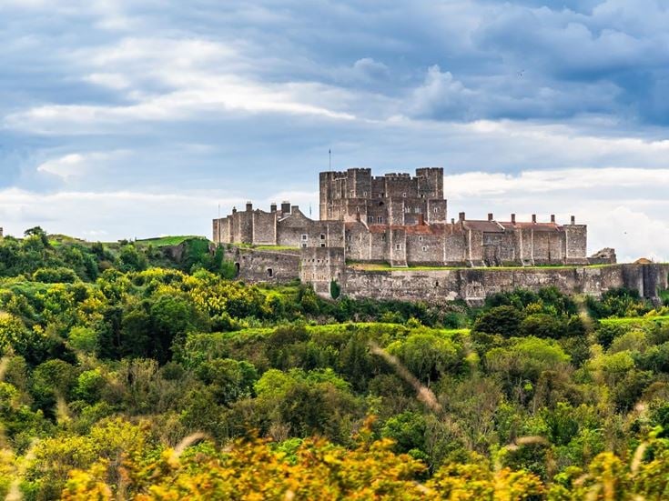 View of Dover Castle over woodlands.