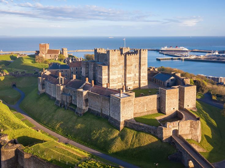 Dover Castle on a hill with the sea in the background.