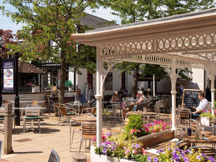 Outdoor seating and flowers outside a restaurant in Dunton Green.