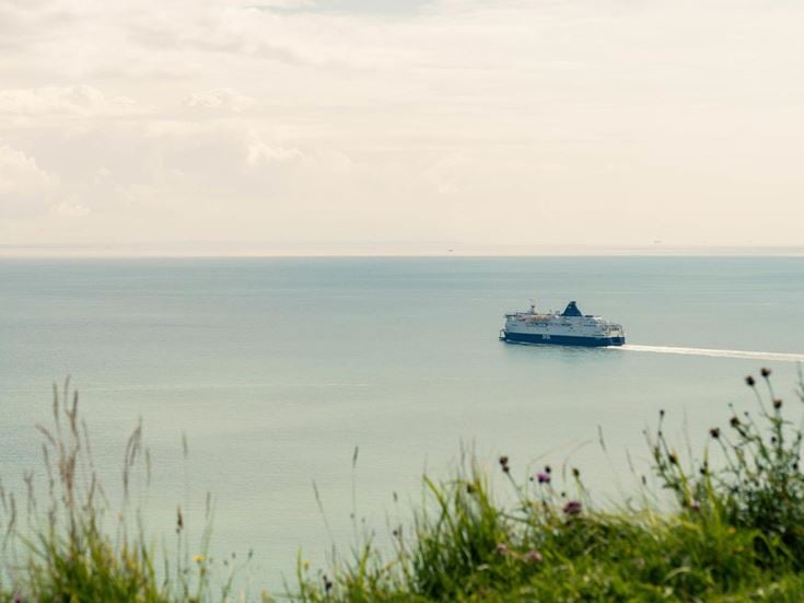 A ferry leaving the coast of Dover in Kent.