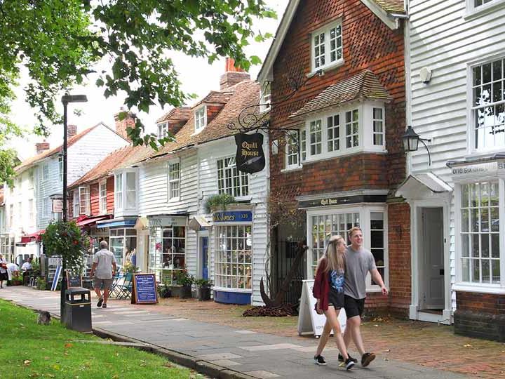 a couple walking down a sidewalk