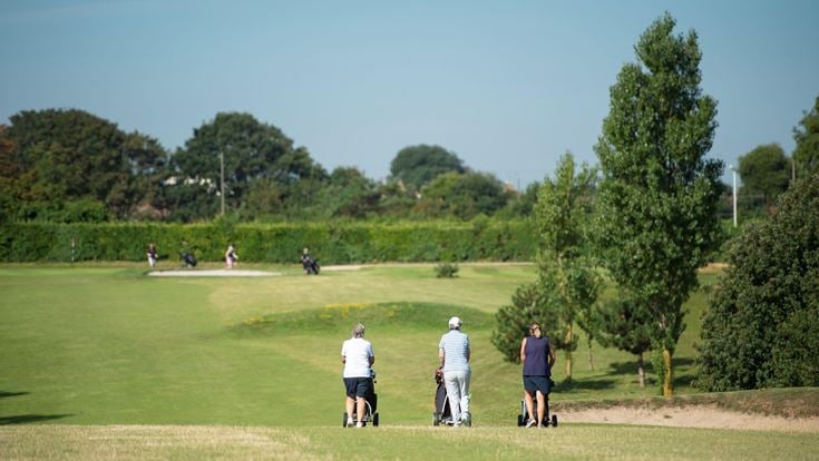 A group of retirees on a golf course in Westgate-on-Sea.